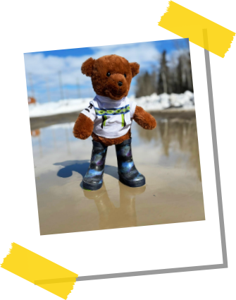 Northy standing in a puddle wearing rubber boots